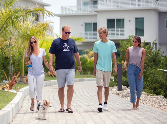 A family enjoys a leisurely stroll along the promenade at NCB's sustainable development, SOLARA.