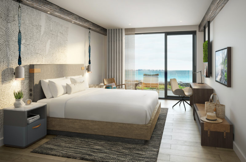 A rendering of a suite at Kailani Cayman with an ocean view and inviting decor 