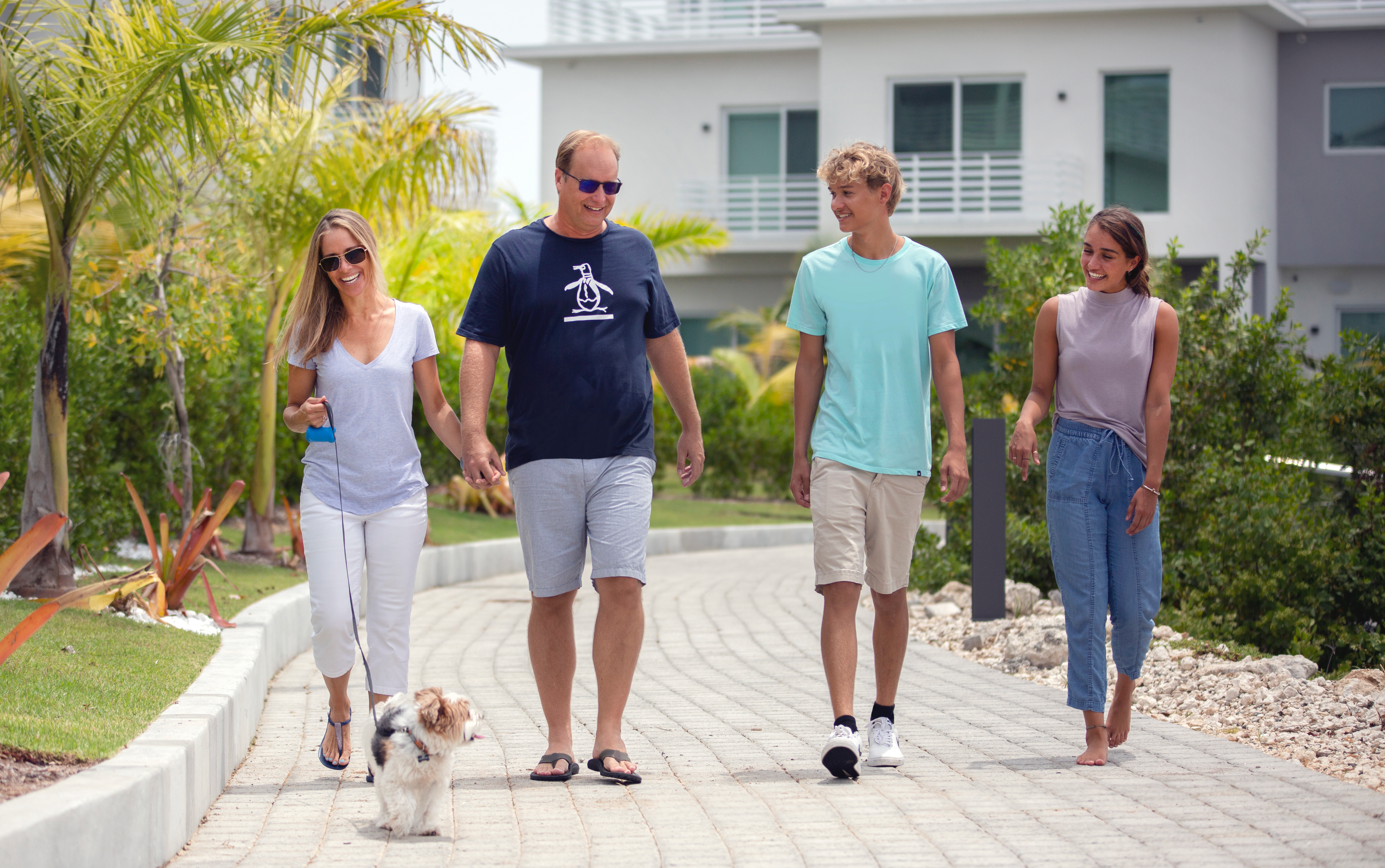 A family walks along the promenade at SOLARA, one of NCB Group's most sustainable communities